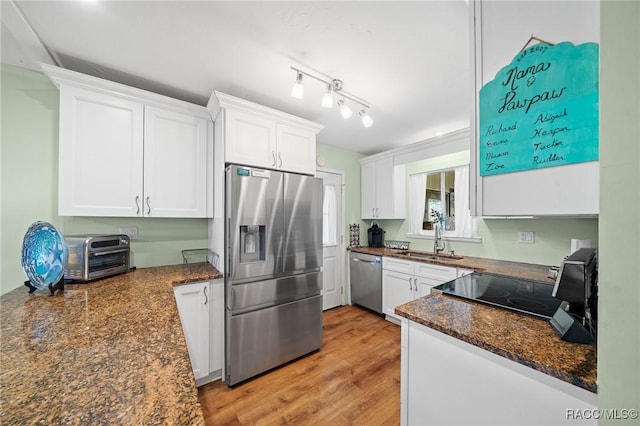 8917 SW 101st Ln, Ocala, FL 34481 - kitchen featuring white cabinetry, stainless steel appliances, a toaster, a sink, and light wood finished floors