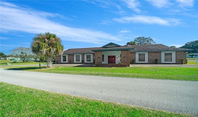 8917 SW 101st Ln, Ocala, FL 34481 - view of front of home with brick siding and a front yard