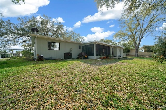 8917 SW 101st Ln, Ocala, FL 34481 - rear view of house with a sunroom, cooling unit, and a yard