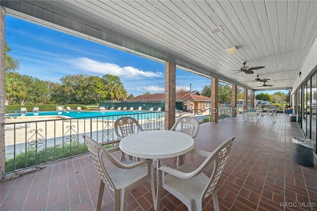 8917 SW 101st Ln, Ocala, FL 34481 - view of patio / terrace with a community pool, outdoor dining area, fence, and ceiling fan