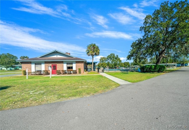 8917 SW 101st Ln, Ocala, FL 34481 - view of front of property featuring a front yard and brick siding