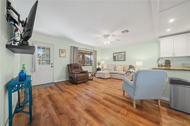 8917 SW 101st Ln, Ocala, FL 34481 - living room with baseboards, visible vents, light wood-style floors, and a ceiling fan