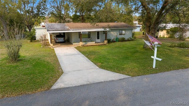 8917 SW 101st Ln, Ocala, FL 34481 - ranch-style home featuring concrete driveway, a front yard, and a carport