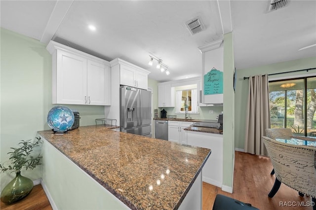 8917 SW 101st Ln, Ocala, FL 34481 - kitchen with white cabinets, a sink, appliances with stainless steel finishes, and visible vents