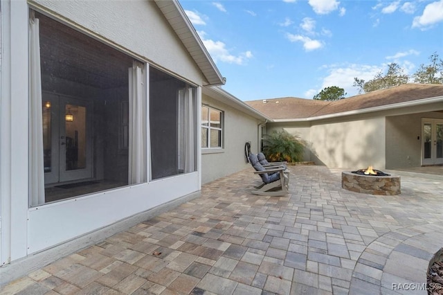 view of patio with an outdoor fire pit and french doors