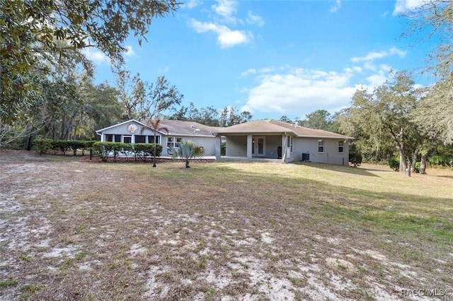 rear view of house featuring a yard