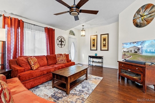 living room with baseboards, dark wood finished floors, and a ceiling fan