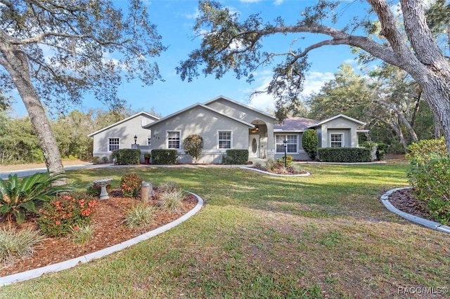 single story home featuring a front lawn and stucco siding