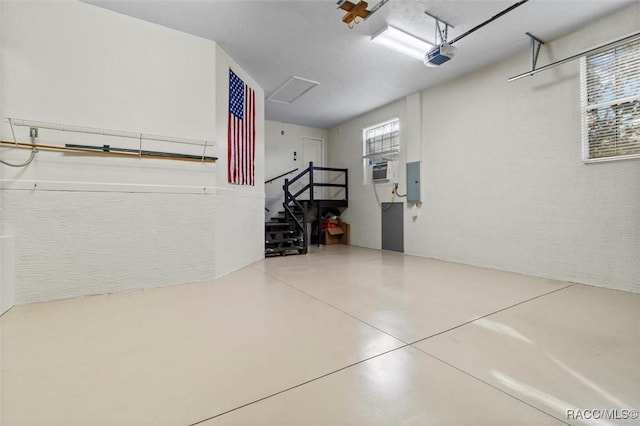 garage with electric panel and a garage door opener