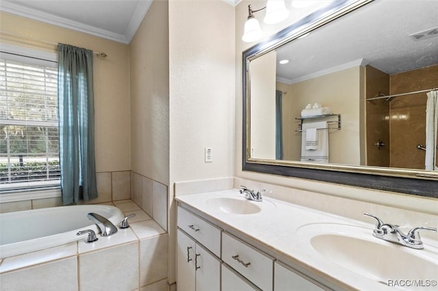 full bathroom featuring ornamental molding, tiled tub, visible vents, and a sink