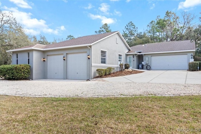 single story home featuring a garage, a front yard, concrete driveway, and stucco siding