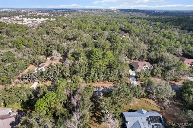 drone / aerial view featuring a view of trees