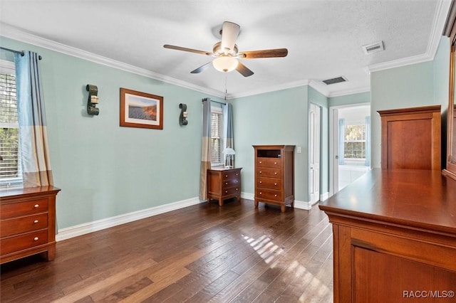 unfurnished bedroom featuring dark wood-style floors, visible vents, ornamental molding, and baseboards