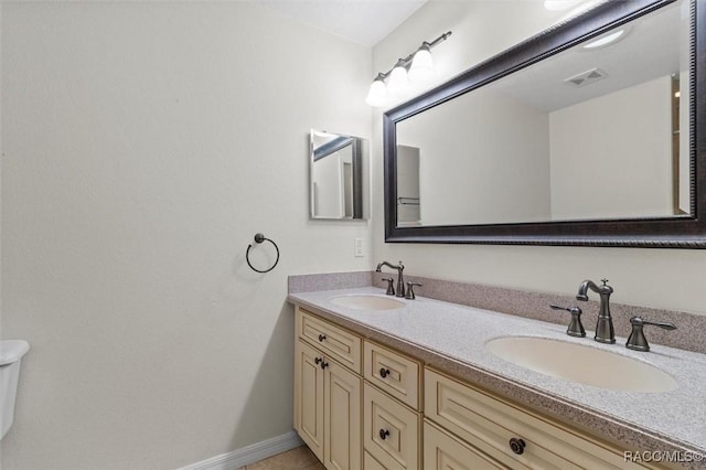 full bathroom featuring visible vents, a sink, toilet, and double vanity