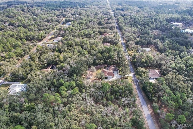 drone / aerial view featuring a forest view