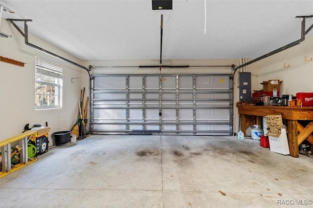 garage featuring electric panel and a garage door opener