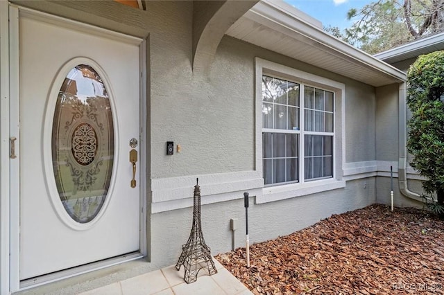 entrance to property with stucco siding