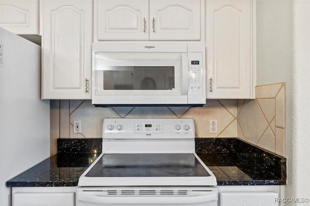 kitchen featuring white appliances, dark countertops, decorative backsplash, and white cabinets