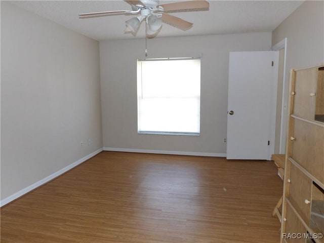 empty room featuring hardwood / wood-style flooring and a textured ceiling