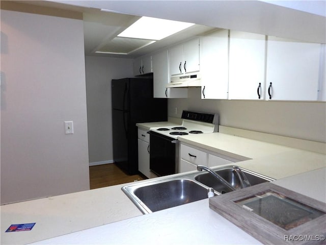 kitchen with electric stove, sink, white cabinetry, black refrigerator, and dark hardwood / wood-style flooring