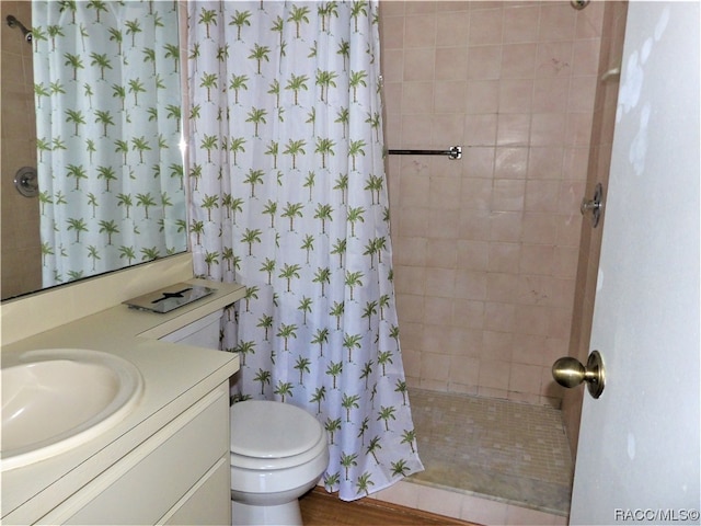 bathroom featuring a shower with shower curtain, vanity, toilet, and hardwood / wood-style floors