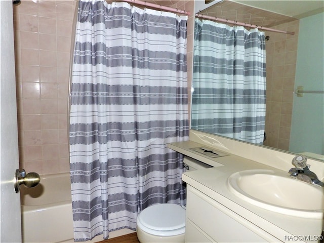 full bathroom featuring shower / tub combo with curtain, vanity, and toilet