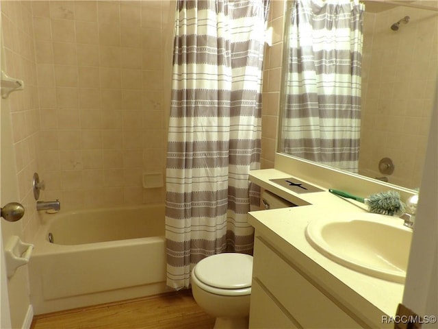 full bathroom featuring vanity, hardwood / wood-style flooring, shower / bath combination with curtain, and toilet