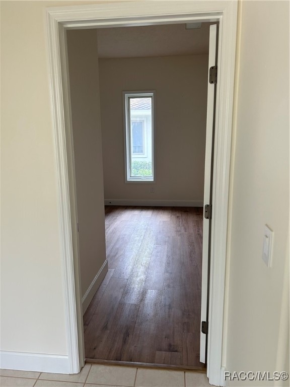 hallway with light hardwood / wood-style flooring