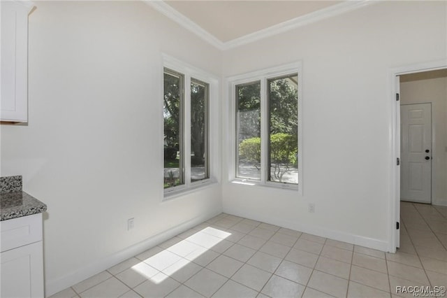 unfurnished dining area featuring a healthy amount of sunlight, light tile patterned floors, and crown molding