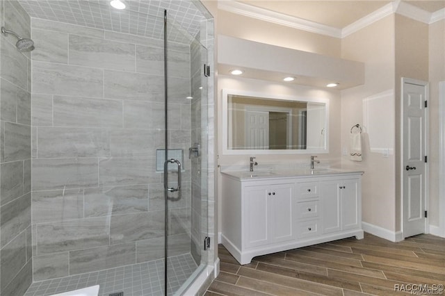 bathroom featuring crown molding, a shower with door, vanity, and hardwood / wood-style flooring