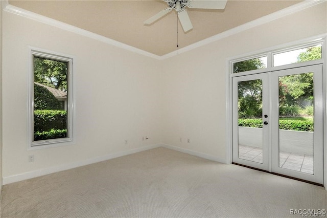 spare room with light carpet, french doors, ceiling fan, and crown molding