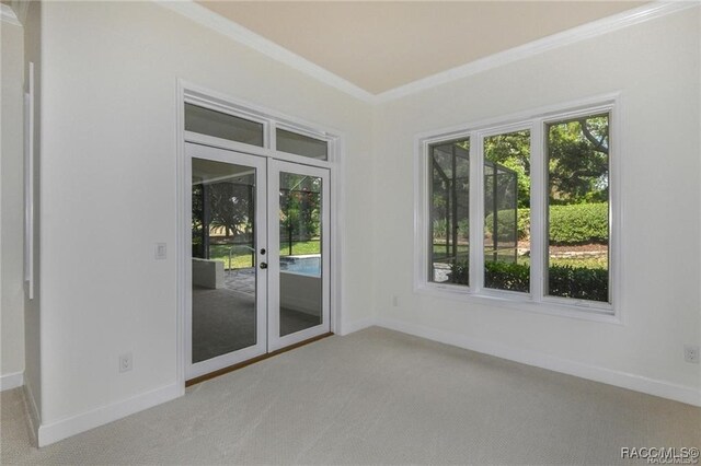 carpeted empty room with french doors and ornamental molding