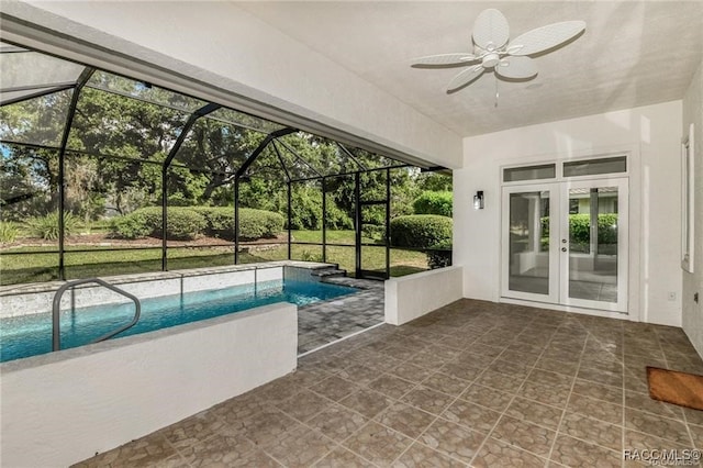 view of swimming pool with french doors, a patio area, ceiling fan, and a lanai