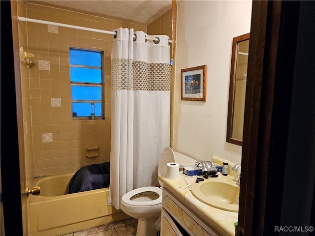 full bathroom featuring tile patterned floors, shower / tub combo with curtain, vanity, and toilet