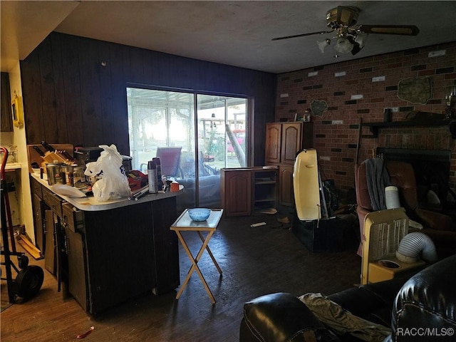 interior space with ceiling fan, wood walls, and dark wood-type flooring