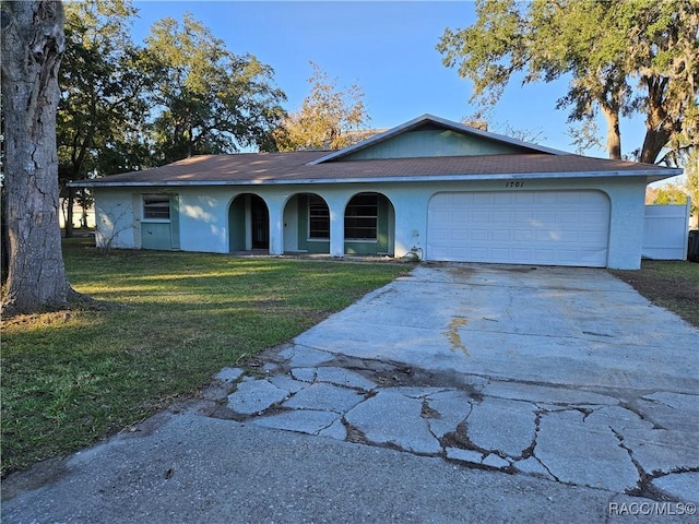 ranch-style house with a front lawn and a garage