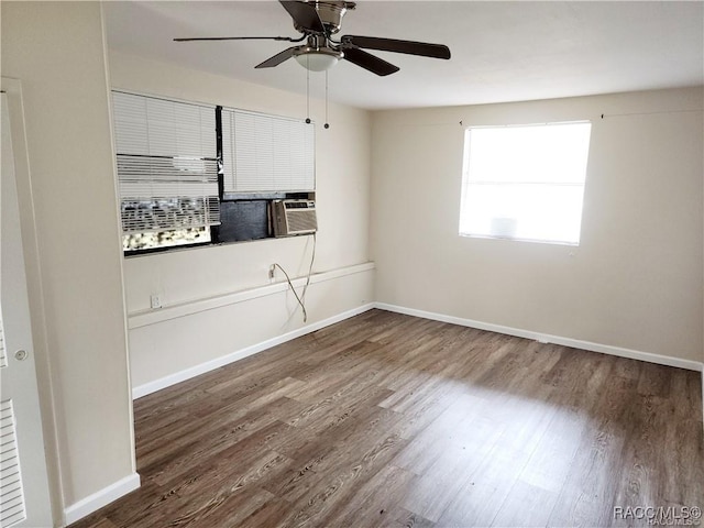 empty room featuring a ceiling fan, baseboards, and wood finished floors