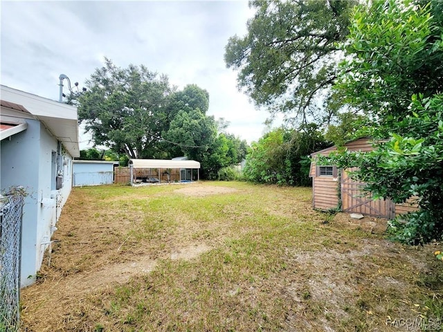 view of yard featuring an outbuilding and a storage shed