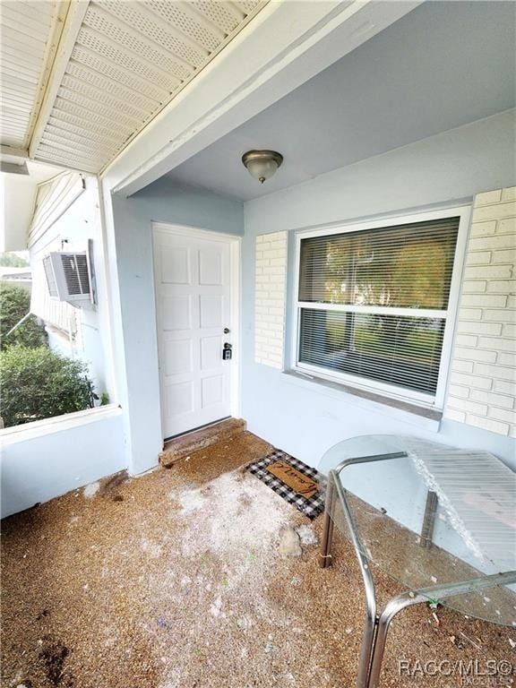 doorway to property with brick siding