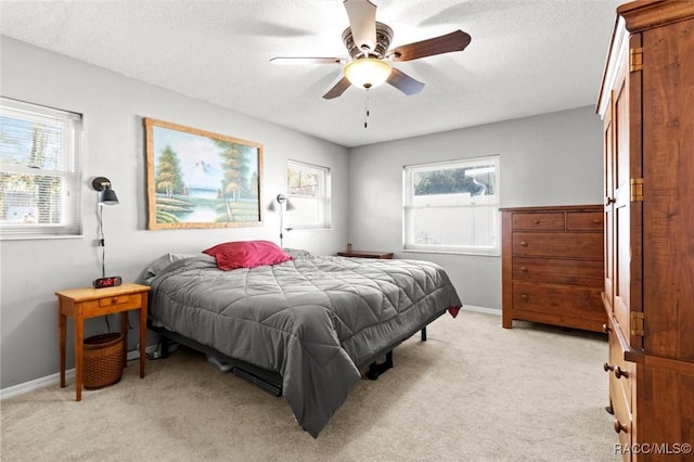 bedroom with light carpet, multiple windows, and baseboards