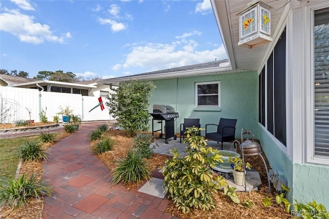 view of patio / terrace featuring a grill and fence