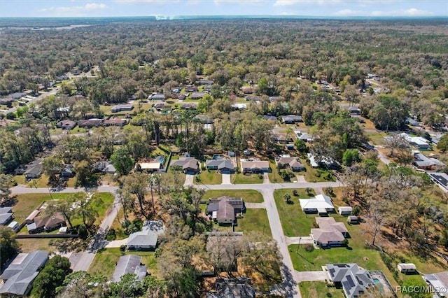 drone / aerial view with a forest view and a residential view