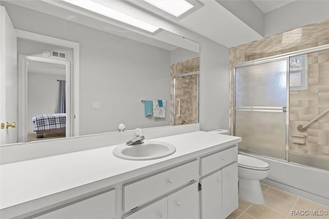 bathroom featuring visible vents, toilet, shower / bath combination with glass door, tile patterned floors, and vanity