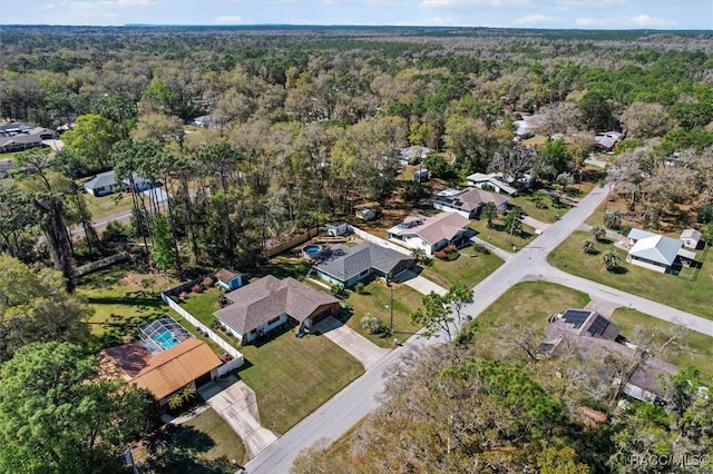 bird's eye view featuring a forest view and a residential view