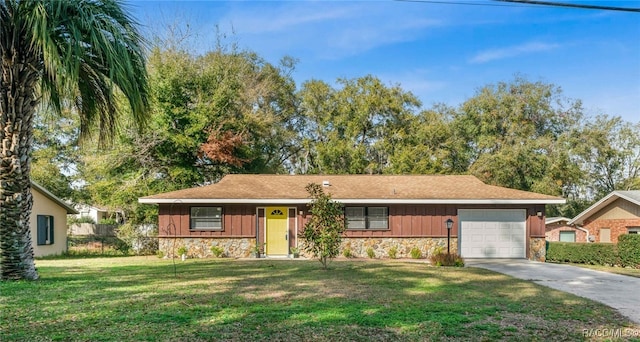 ranch-style house with a garage and a front yard