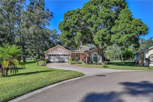 view of front of home with a front lawn and a garage