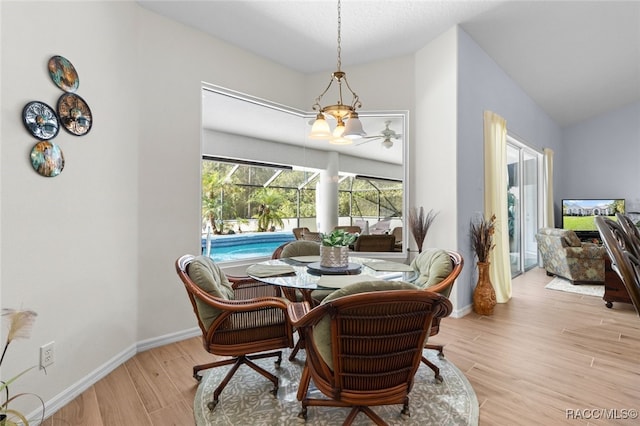 5705 N Bedstrow Blvd, Beverly Hills, FL 34465 - dining room featuring wood finished floors, a chandelier, and lofted ceiling