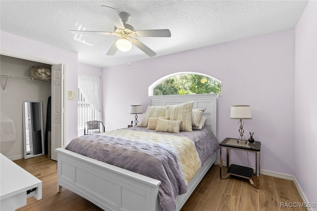 5705 N Bedstrow Blvd, Beverly Hills, FL 34465 - bedroom with wood finished floors, a ceiling fan, a closet, and a textured ceiling