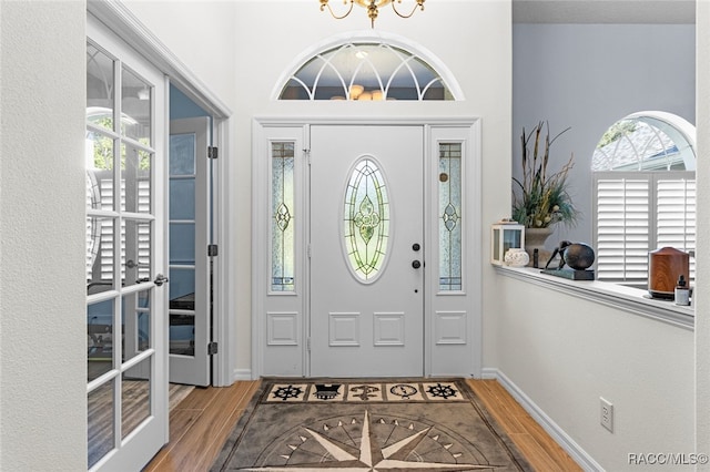 5705 N Bedstrow Blvd, Beverly Hills, FL 34465 - foyer featuring wood finished floors, a chandelier, and a high ceiling