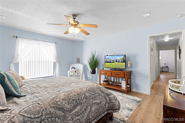5705 N Bedstrow Blvd, Beverly Hills, FL 34465 - bedroom featuring wood finished floors, a textured ceiling, and a ceiling fan